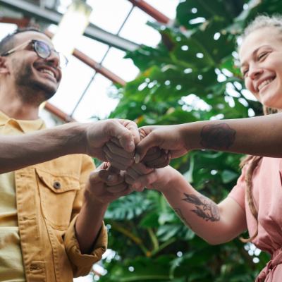 Two people bumping fists while smiling