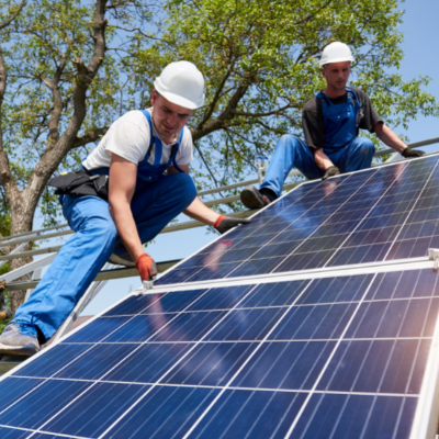 two people installing a solar panel